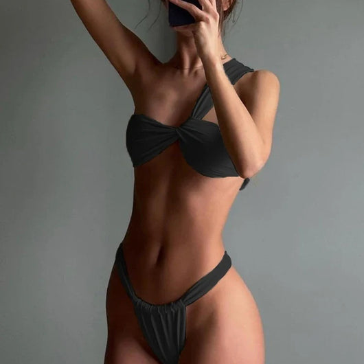 White one-shoulder bikini with a twisted front top and ruched, high-cut bottom modeled by a woman. - Image 7