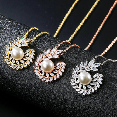 Elegant pearl and cubic zirconia jewelry set with a necklace and two earrings, featuring a wreath design. - Image 4