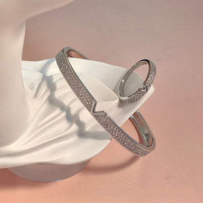 V-shaped 18K gold electroplated bracelet and ring set with pave clear stones on a white stand. - Image 7