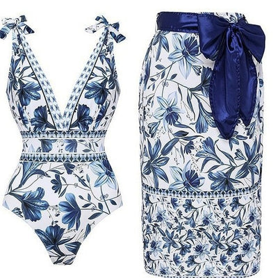 Women's white one-piece swimsuit with deep V-neck, blue floral and geometric patterns, and tie-shoulder straps. - Image 19