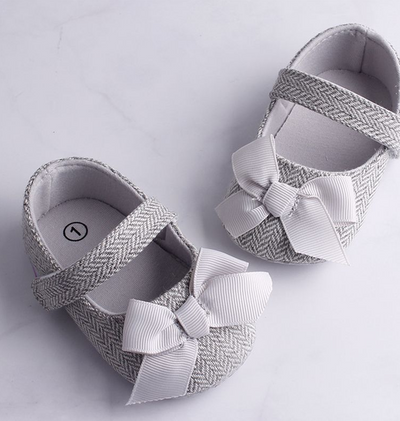 Grey herringbone baby crib shoes with white grosgrain bows and a single strap, perfect for toddlers. - Image 11