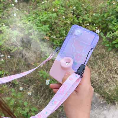 Pink and clear portable handheld humidifier with a fruit pattern, mist nozzle, and a matching pink neck lanyard. - Image 14
