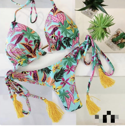 Women's tropical floral print bikini with a halter top, ruffled edges, and tie-side bottoms with pink tassels. - Image 25