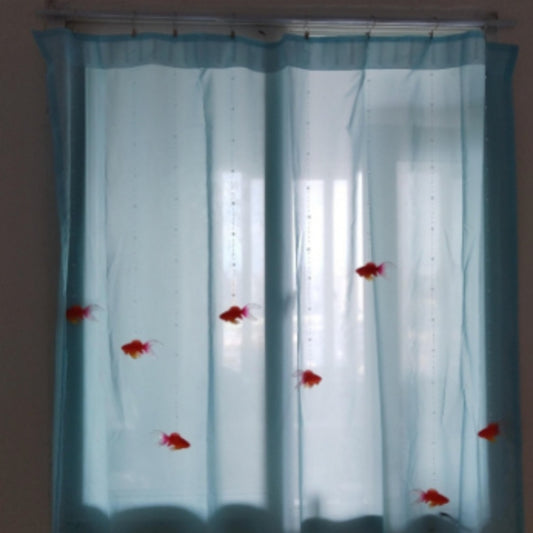DIY goldfish curtain kit with sheer blue fabric panels, beaded wires, and red goldfish decorations hanging in a window.