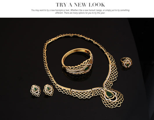 Four-piece gold-tone jewelry set with green teardrop accents and clear rhinestones, including a necklace, bracelet, earrings, and ring. - Image 5