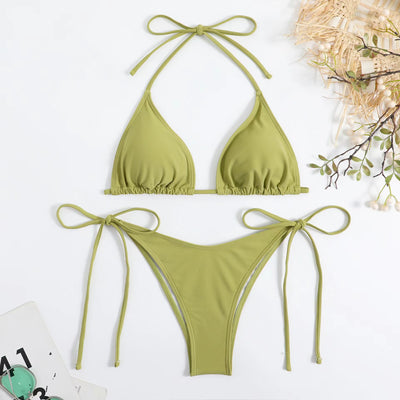 Neon yellow halter bikini with triangle top and tie-side bottoms, displayed on a light wood surface. - Image 43