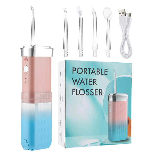 Portable water flosser in gradient pink and blue with four nozzles, a charging cable, and its product box. - Image 5