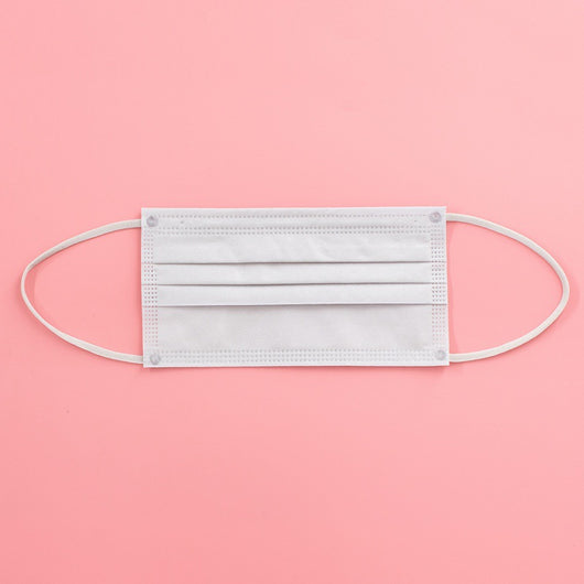 Light pink disposable face mask with white ear loops, featuring pleats for a comfortable fit. - Image 8