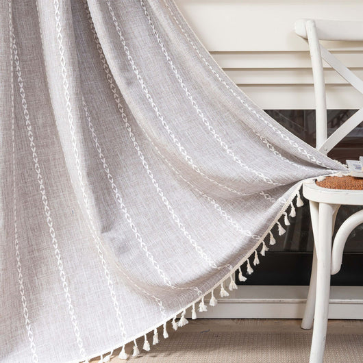 Black polyester curtain with white jacquard multi-line pattern and black tassels, draped over a white chair. - Image 11