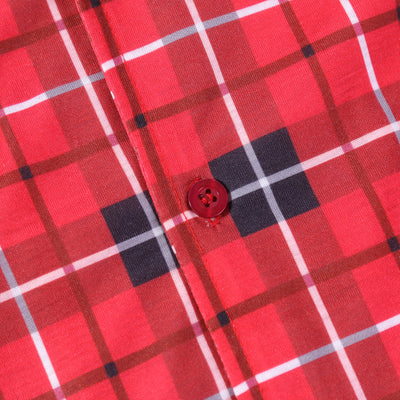 Family of four and their dog wearing matching red and black plaid Christmas pajamas, smiling against a white background. - Image 18