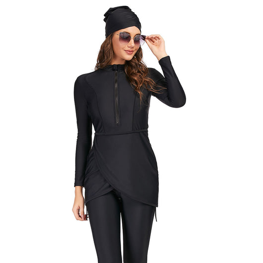 Woman wearing a black conservative Muslim swimsuit with a long-sleeved top, draped peplum, leggings, and swim turban. - Image 4
