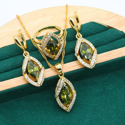 Gold-toned jewelry set with green marquise gemstones and clear accents, including a bracelet, necklace, earrings, and ring. - Image 13