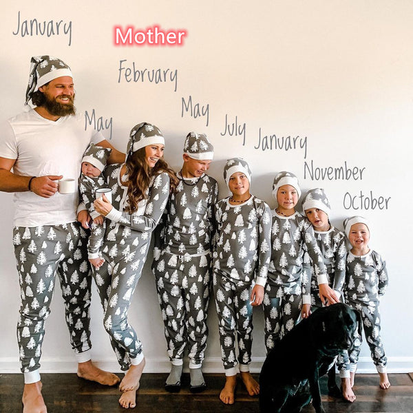 Family of seven and a dog in matching grey Christmas tree print pajamas with white cuffs and beanies. - Image 6