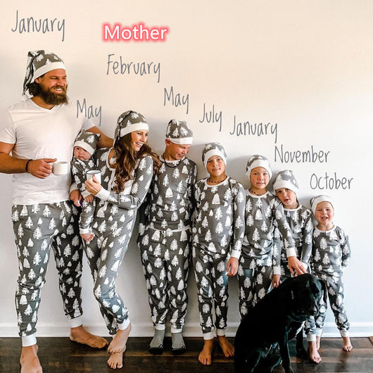 Family of seven and a dog in matching grey Christmas tree print pajamas with white cuffs and beanies. - Image 6