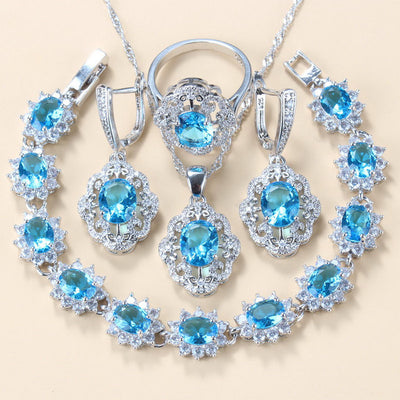 Four-piece jewelry set with silver-tone settings, featuring oval purple cubic zirconia stones surrounded by clear accents. - Image 14