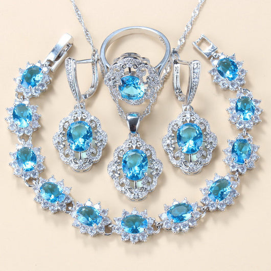 Four-piece jewelry set with silver-tone settings, featuring oval purple cubic zirconia stones surrounded by clear accents. - Image 14