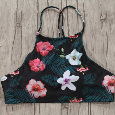 Black high-neck halter bikini top and high-waisted bottoms with pink and white floral leaf print. - Image 12