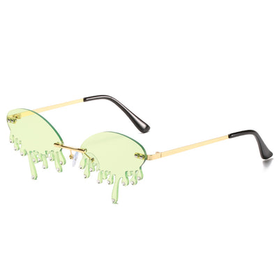 Rimless sunglasses with dark gray dripping liquid-shaped lenses, silver studs, and gold metal frames. - Image 16