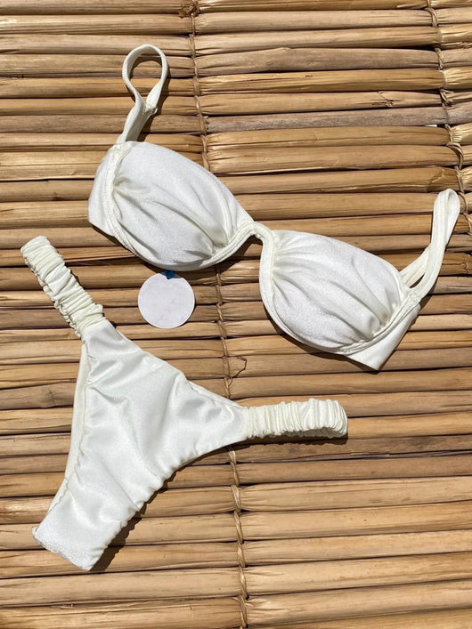 Rust underwire bikini set with ruched top and high-cut bottom, displayed on a woven mat. - Image 20