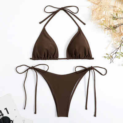 Neon yellow halter bikini with triangle top and tie-side bottoms, displayed on a light wood surface. - Image 6