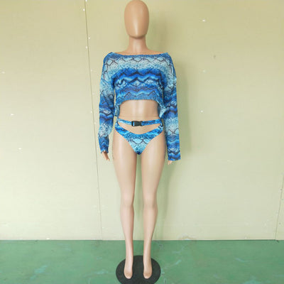 Woman in a purple and pink snakeskin print three-piece swimsuit with an off-shoulder crop top and high-waisted bottoms. - Image 28