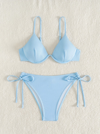 Black ribbed two-piece bikini with an underwire top and tie-side bottoms on a white marble surface. - Image 8