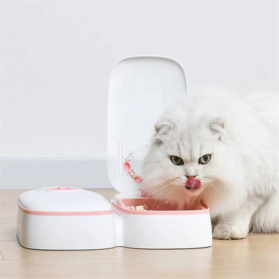 White automatic pet feeder with a pink timer dial and an embossed paw print on the lid. - Image 16