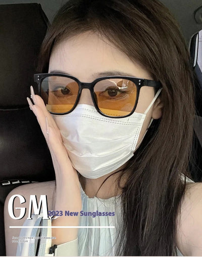 Black full-frame sunglasses with brown lenses, featuring a boxy style and visible dimensions. - Image 22