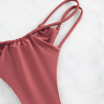 Red bean paste women's bikini swimwear with a triangle top and high-cut double-strap bottoms, laid flat. - Image 15