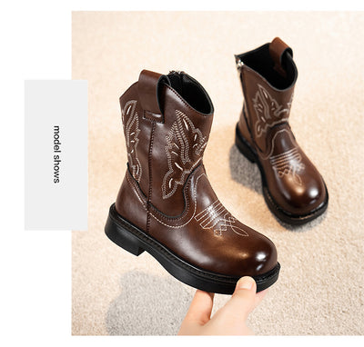 Girls' brown Martin boots with white ethnic embroidery, side zippers, and black soles, displayed on a light carpet. - Image 25