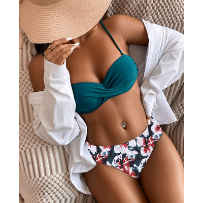 Teal twisted bandeau bikini top with tropical leaf print high-waisted bottoms on a model wearing a white shirt. - Image 18
