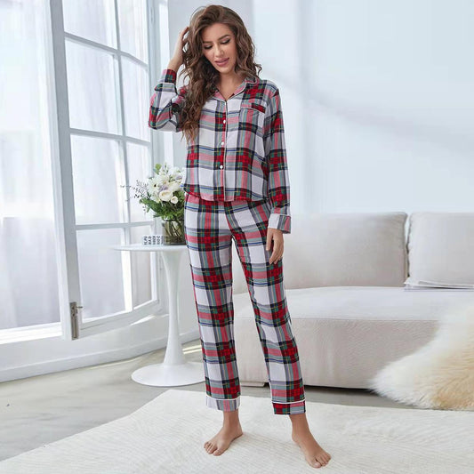 Woman wearing a red, white, and green plaid two-piece pajama set with a button-up top and long pants.
