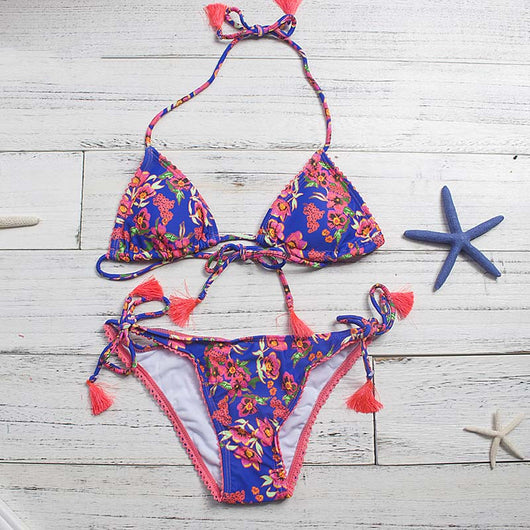 Women's blue floral print bikini with pink flowers, green leaves, coral trim, and orange tassels on ties. - Image 3