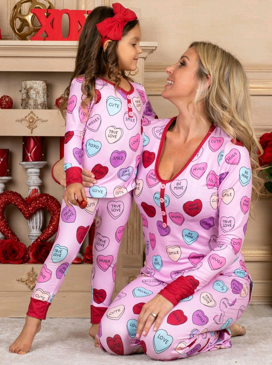 Pink long-sleeve pajama set with a conversation heart print, red Henley neckline, and matching full-length pants. - Image 2