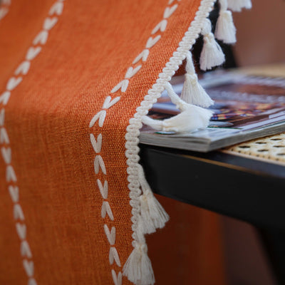 Black polyester curtain with white jacquard multi-line pattern and black tassels, draped over a white chair. - Image 21