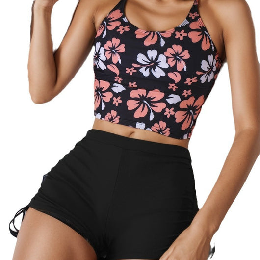 Women's two-piece swimsuit featuring a black halter crop top with pink and white floral print and solid black swim shorts. - Image 5