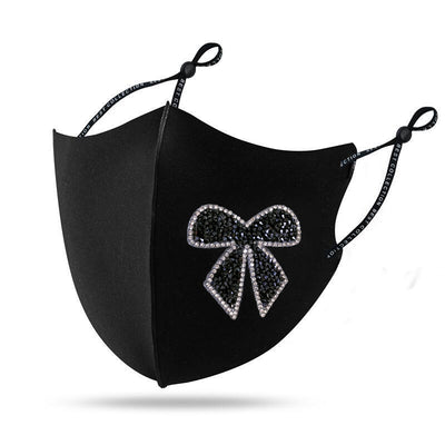 Black cloth face mask with a sparkling red and silver rhinestone bow design and adjustable ear loops. - Image 6