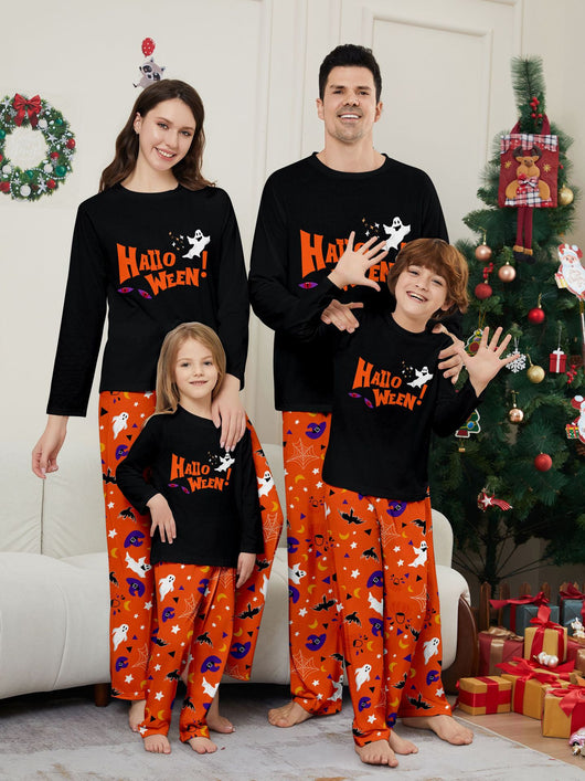 Family of four wearing matching black and orange Halloween long-sleeve pajamas with ghost and bat prints. - Image 6