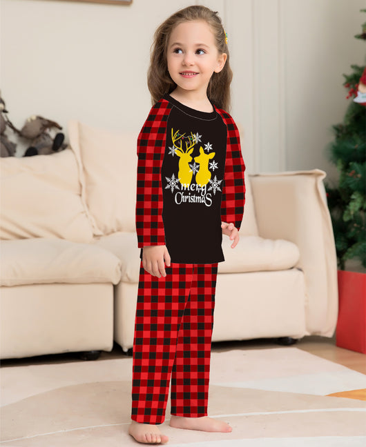 Two children in matching black and red buffalo plaid Christmas pajamas with golden deer and "Merry Christmas" print. - Image 7