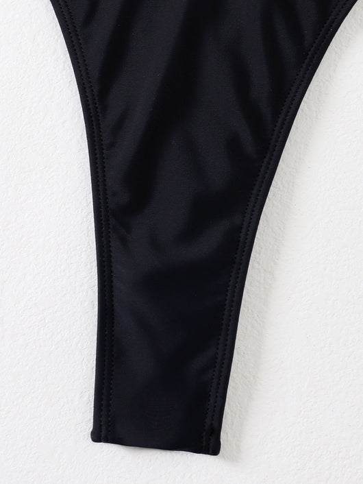 Black two-piece swimsuit with a bandeau top featuring a central O-ring, cut-out, and white zigzag embroidered trim, paired with matching high-cut bikini bottoms - Image 4