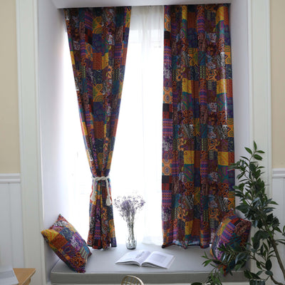 Bohemian retro style cotton linen curtains with a vibrant geometric patchwork pattern, one tied back with a rope.