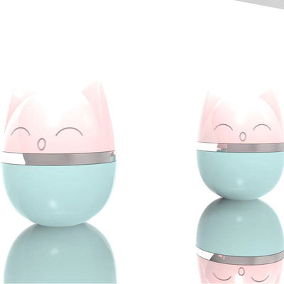 Pink cat-shaped tumbler toy with a feather attachment, featuring a cute face and silver band. - Image 7