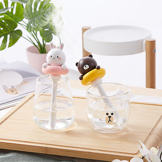 Two white and pink rabbit-shaped mini portable humidifiers, one facing forward and one showing the USB port.