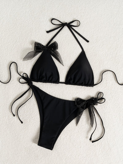 Black strappy backless bikini two-piece swimsuit for women with triangle top and tie-side bottoms, featuring sheer polka dot bows. - Image 15