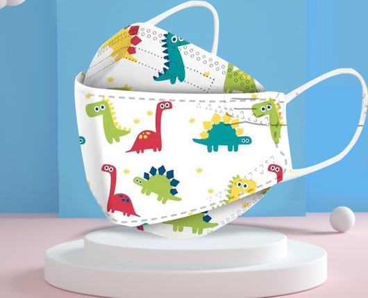 Two white children's face masks with colorful cartoon dinosaurs, including red, green, and teal, on a white display stand.