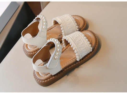 Children's white sandals with pearl ankle straps, woven front strap, and brown sole, featuring a Velcro closure. - Image 7