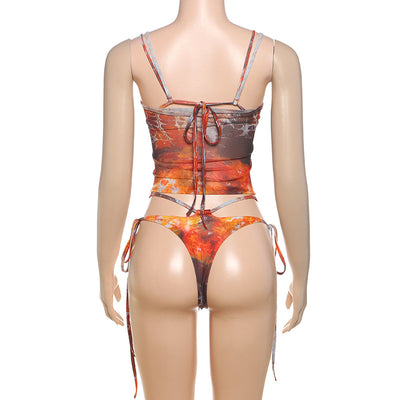 Women's fashionable three-piece bikini set with an abstract orange, brown, and blue print. Features a triangle top, mesh mini skirt, and lace-up details with be - Image 14