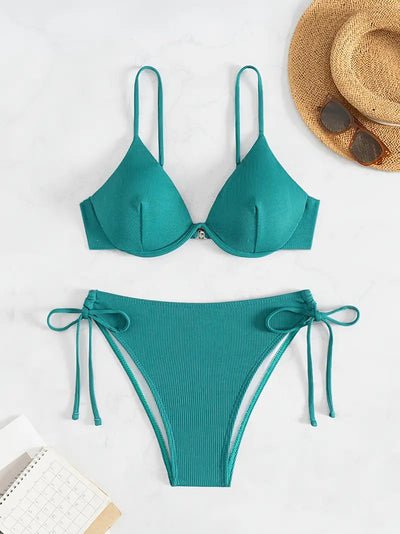 Black ribbed two-piece bikini with an underwire top and tie-side bottoms on a white marble surface. - Image 27