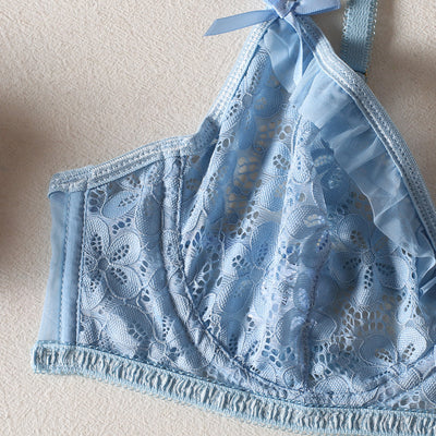 Light blue lace bralette and thong lingerie set with bow details and ruffle trim, displayed on a light surface. - Image 10