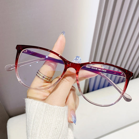 Black full-frame round anti-blue light glasses held by a hand with a gold ring and light blue gradient nails. - Image 4